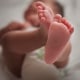 Close up of mixed race newborn baby girl's feet