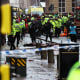 Members of the emergency services treat members of the public in a busy street