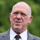 Tom Homan speaks while standing outside