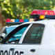 Careful, long exposure using tripod to capture flashing police car lights during daylight.