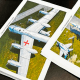 Two photos of planes are laid on a table