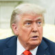 Donald Trump speaks while seated