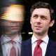Jon Ossoff looks upwards, a reflection of himself is beside him