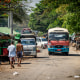 People walk down a rural road.