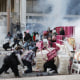 Police fire tear gas and break through a barricade