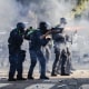 Police shoot projectiles outside on the street