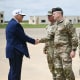 President Donald Trump shakes hands with Lt. Gen. Jonathan Braga, commanding general of the US Army Special Operations Commany, as he arrives to watch a military demonstration at Fort Bragg near Fayetteville, N.C., on June 10, 2025.  