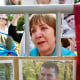 A tearful woman standing behind a barrier