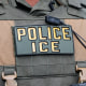 An ICE officer's bulletproof vest closeup