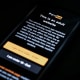 The age-restriction warning screen of the website PornHub is displayed on a digital phone screen