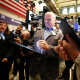 A trader smiles on the floor of NYSE