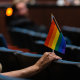 A person holds an inclusive pride flag during a Fairfax County School Board meeting after a rally in support of inclusive Family Life Education at Luther Jackson Middle School in Falls Church, Va. on July 14, 2022. 