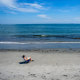 A person sits on the beach.