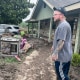 Matt Meagher stands in his flood damaged backyard
