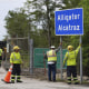 Workers install a sign reading "Alligator Alcatraz" at the entrance to a new migrant detention facility at Dade-Collier Training and Transition facility, Thursday, July 3, 2025, in Ochopee, Fla. 