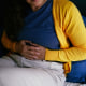 Person Experiencing Abdominal Discomfort While Resting at Home