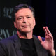 James Comey gestures while speaking.