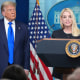 Attorney General Pam Bondi speaks to reporters as President Donald Trump listens.