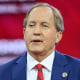Ken Paxton gestures while speaking.
