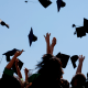 graduates throwing their caps in the sky