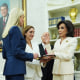 Jeanine Pirro raises her hand during a swearing-in ceremony as President Trump looks on.
