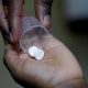 A nurse dispenses an anti-retroviral drug to a child in Kenya
