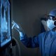 two surgeons analyzing a patient’s medical scans during surgery