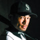 Ichiro Suzuki poses holding a baseball bat in his Mariners uniform