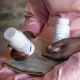 Florence Makumene holds HIV medication