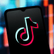 The TikTok logo displayed on a smartphone screen. 