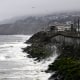 The Pacific Ocean along coastline as a wave crashes onto the land