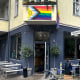 Exterior view of the 'Das Hoven' cafe, and LGBTQ flag is draped on the front