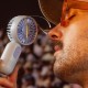 a man holding a portable fan