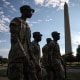 National Guard members walk outside near the Washington Monument
