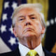 President Donald Trump listens to questions from reporters in the Oval Office on Aug. 7, 2025.