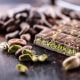 Dubai Chocolate bar with green kadayif and pistachio spread with pistachio nuts - close up