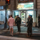 Sean Dunn holds a sandwich as he interacts with Border Patrol and FBI agents outside of a Subway location holding a sandwich