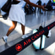 A passenger walk past an Air Canada line rope