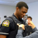 Officer Jon Luke Evans receives his police badge.