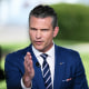 Pete Hegseth gestures during a television interview 