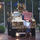 A protester is blown around in the rain as members of the D.C. National Guard take shelter in their vehicle outside Union Station in Washington