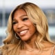 Serena Williams smiles while seated