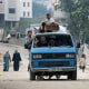 Palestinians transport their belongings as they flee the Abu Iskandar neighborhood of northern Gaza City on Aug. 22, 2025. 