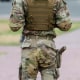 A gun is seen in the holster on someone's pant leg
