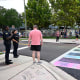 Orlando Police officers warn people not to apply chalk to the crosswalk outside of the Pulse Interim Memorial,