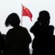 A Chinese flag is raised in Tiananmen Square 