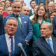 Robert F. Kennedy sits next to Greg Abbott, right, surrounded by other politicians