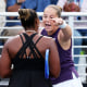 Jelena Ostapenko pointing at Taylor Townsend, who's back is facing the camera