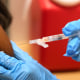 A pharmacist gives a COVID-19 vaccine in Cypress, Texas in 2023.