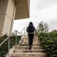 Rear view of a university student walking up the stairs